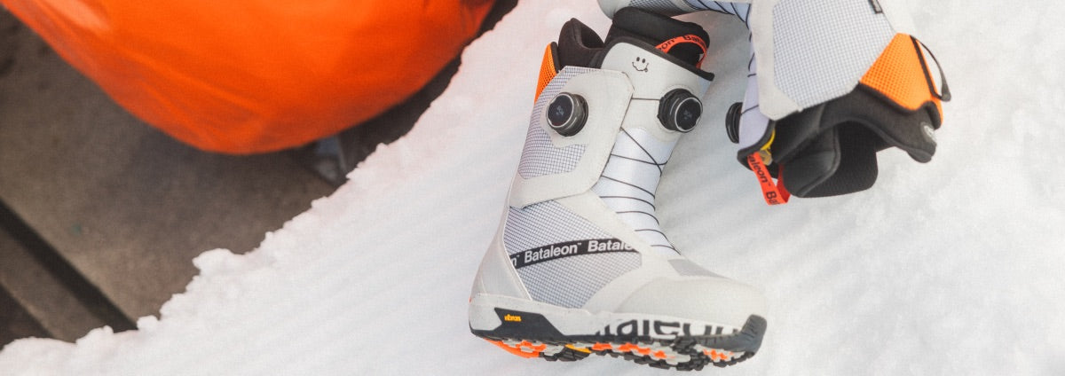 The bataleon mens snowboard boots being displayed with the mountains in the background