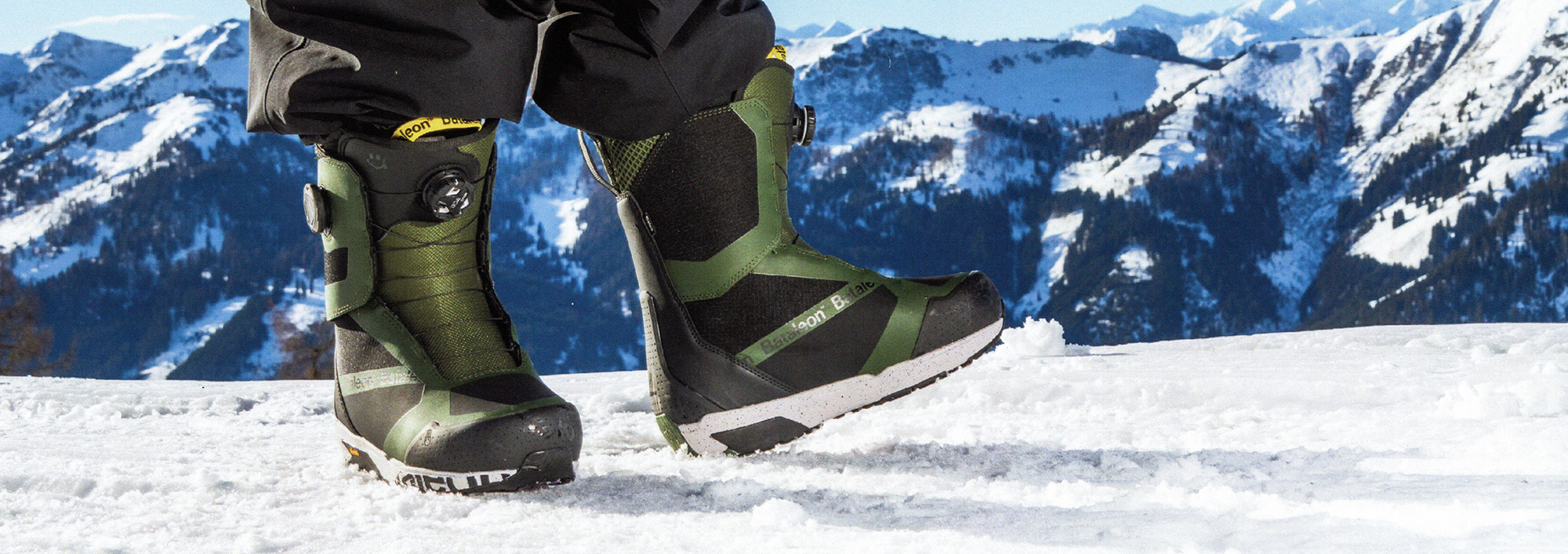 The bataleon mens snowboard boots being displayed with the mountains in the background