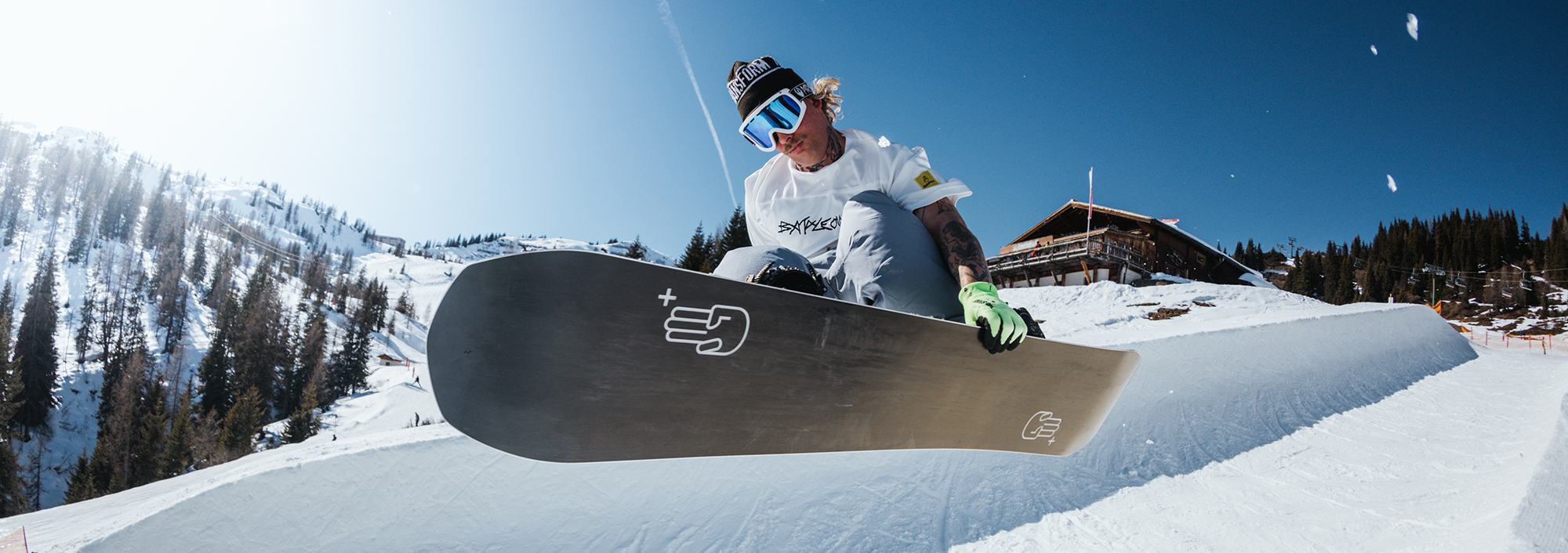 Snowboarder jumping in the halfpipe grabbing his board using the bataleon plus series snowboard