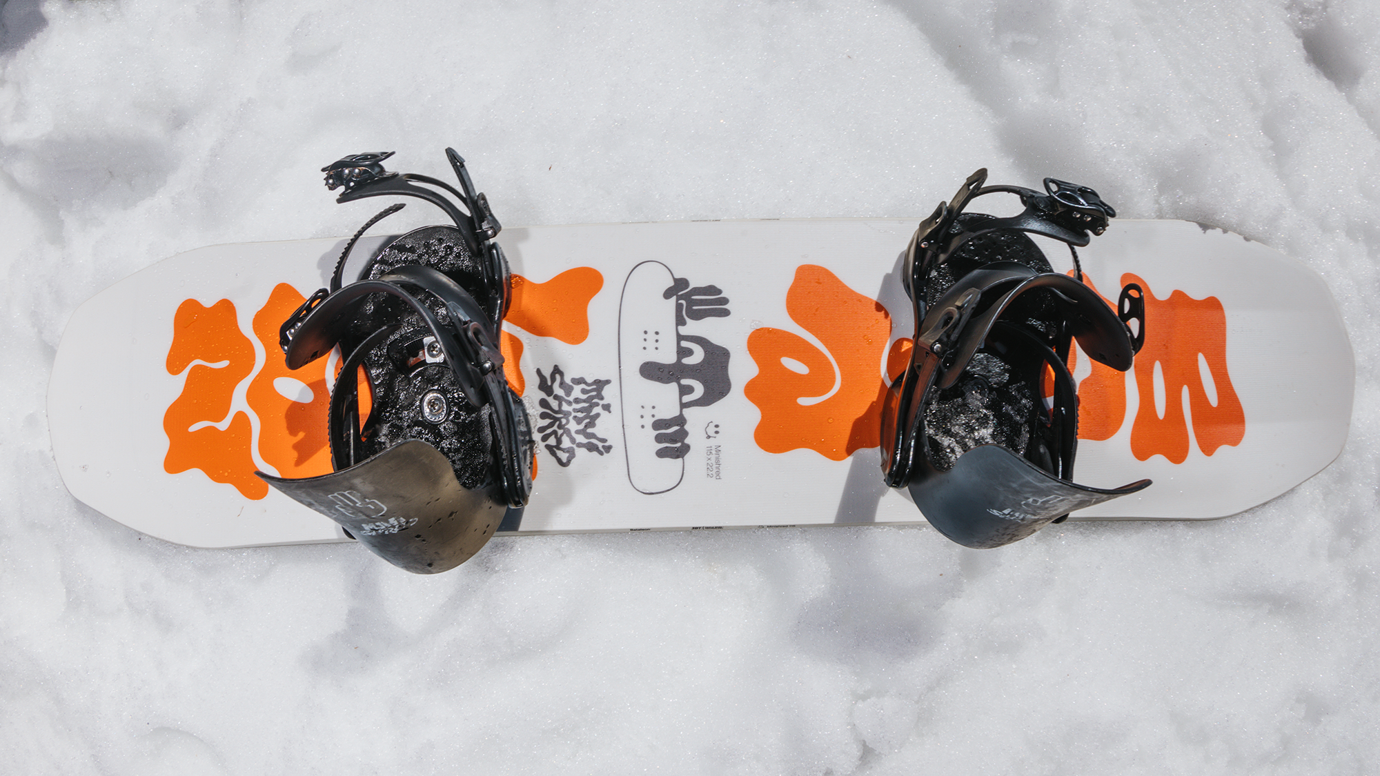 youth snowboard from bataleon laying in the snow