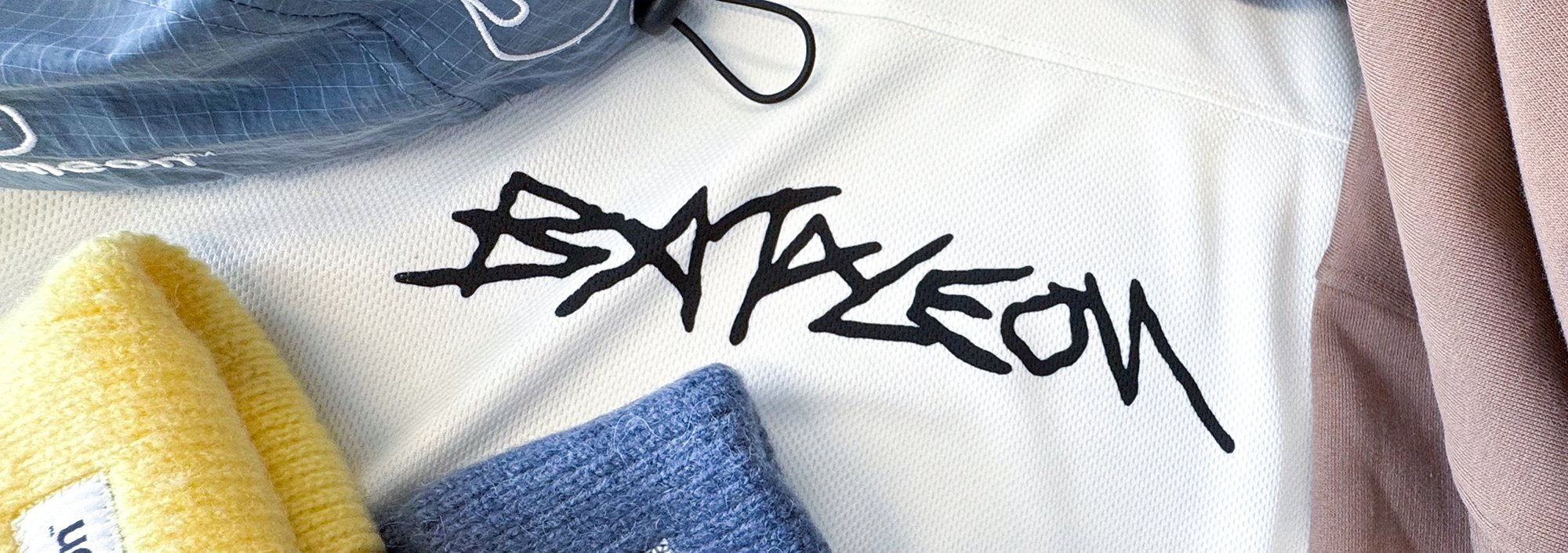 Bataleon snowboard apparel blends performance and style. This is being shown with an image of the bataleon tshirt being strechted while showing the bataleon logo